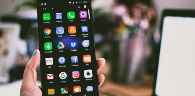 selective focus photography of person holding turned on smartphone