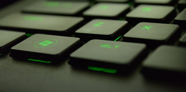 close up photography of black and green computer keyboard keys